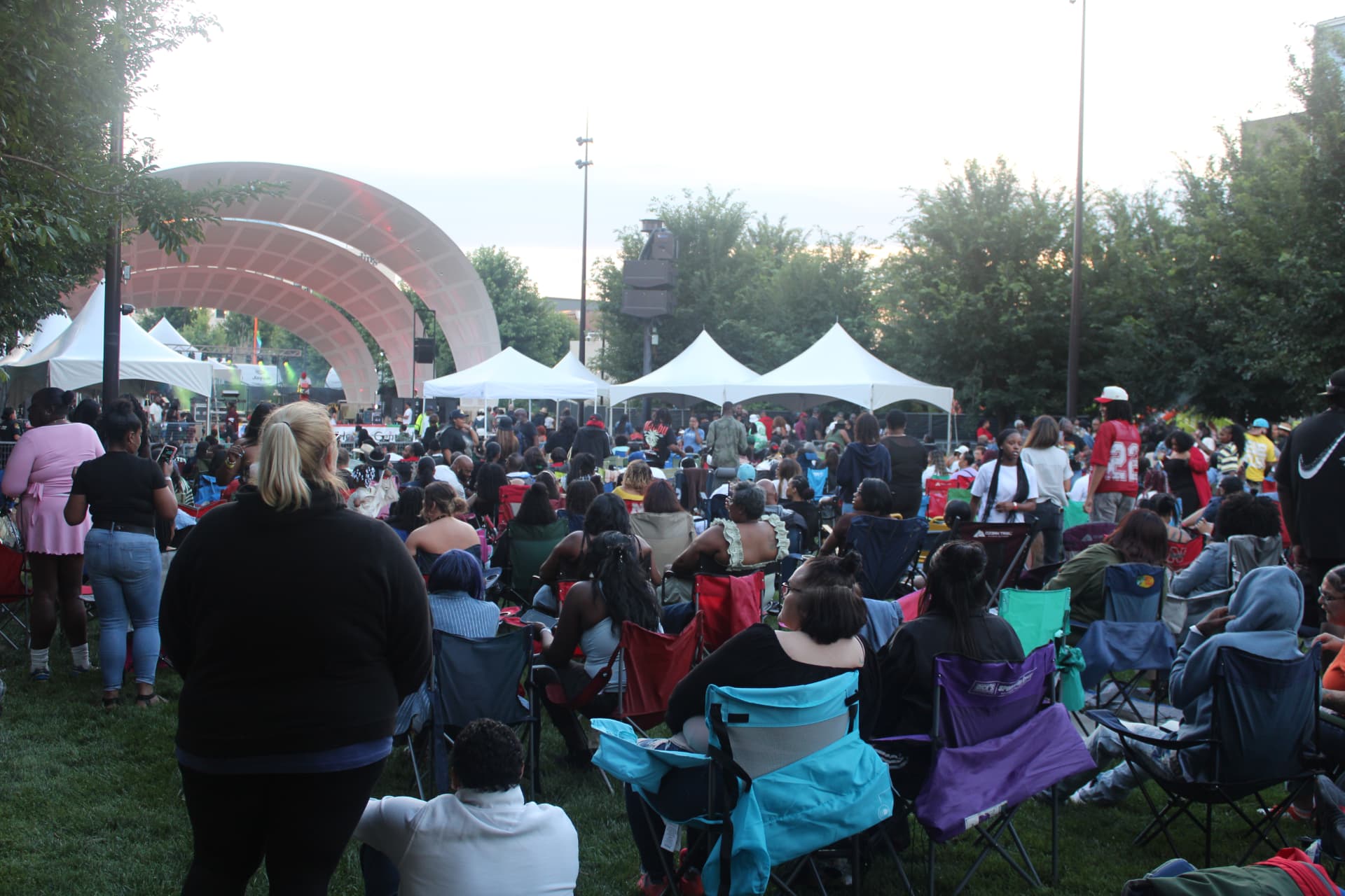 Large outdoor concert audience gathered before a professionally produced stage