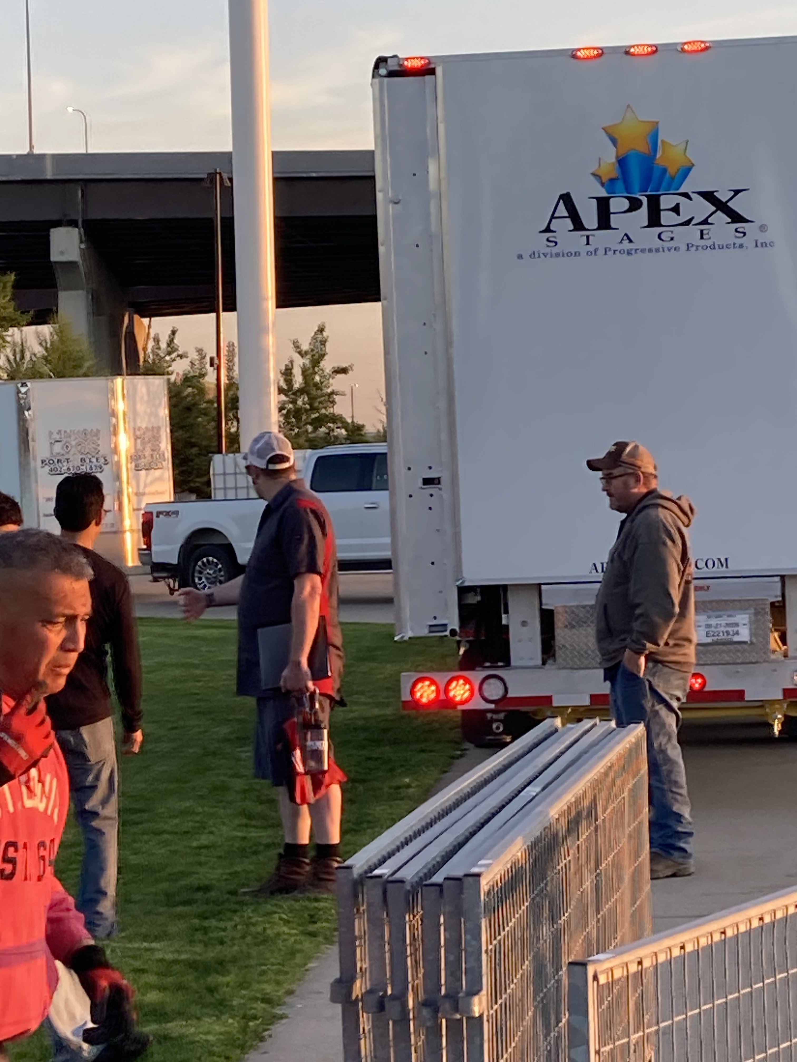 Rhino-Apex-Stage trailer arriving on site at dusk before an event setup