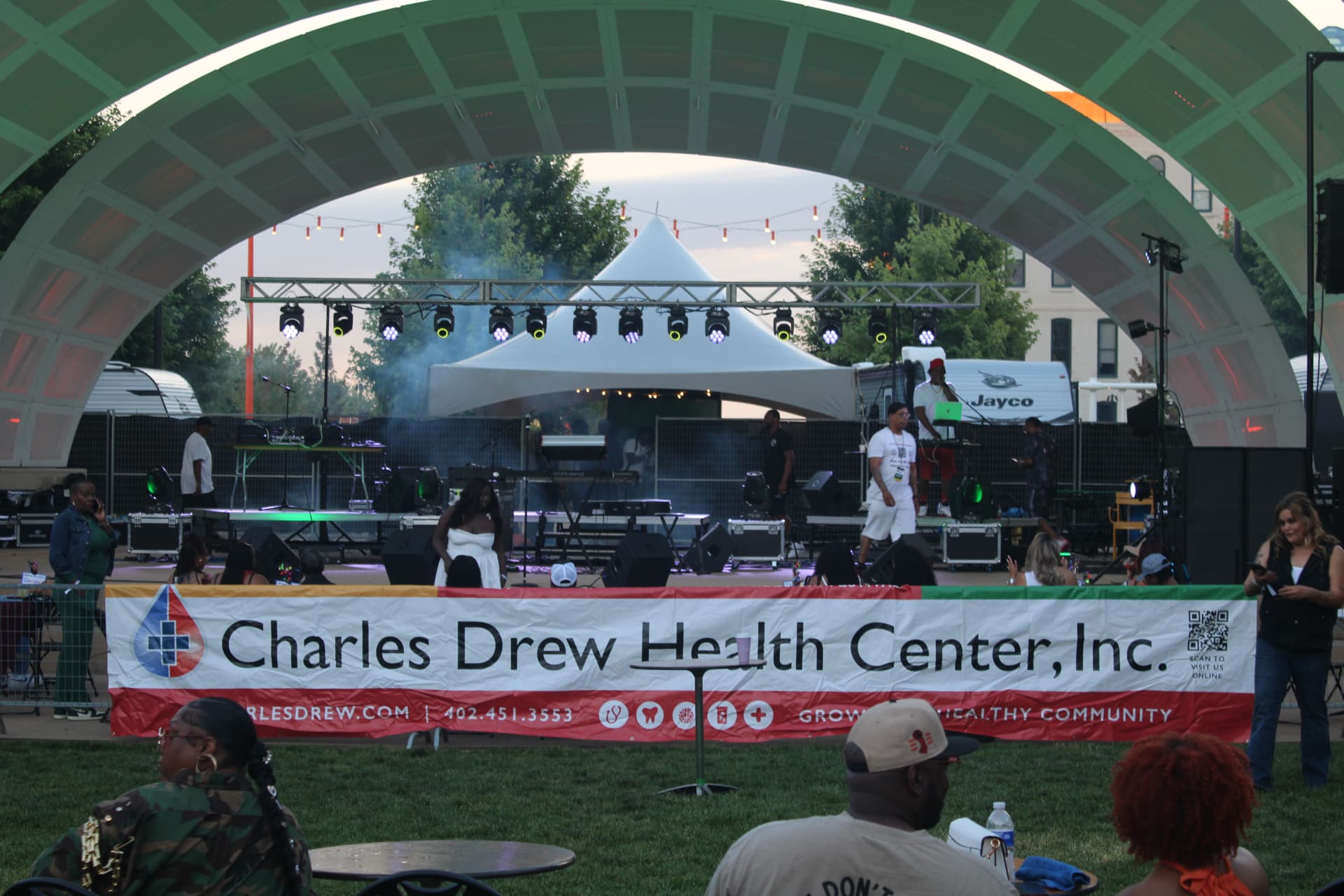 Outdoor festival stage with lighting and sound production at the Charles Drew Health Center event